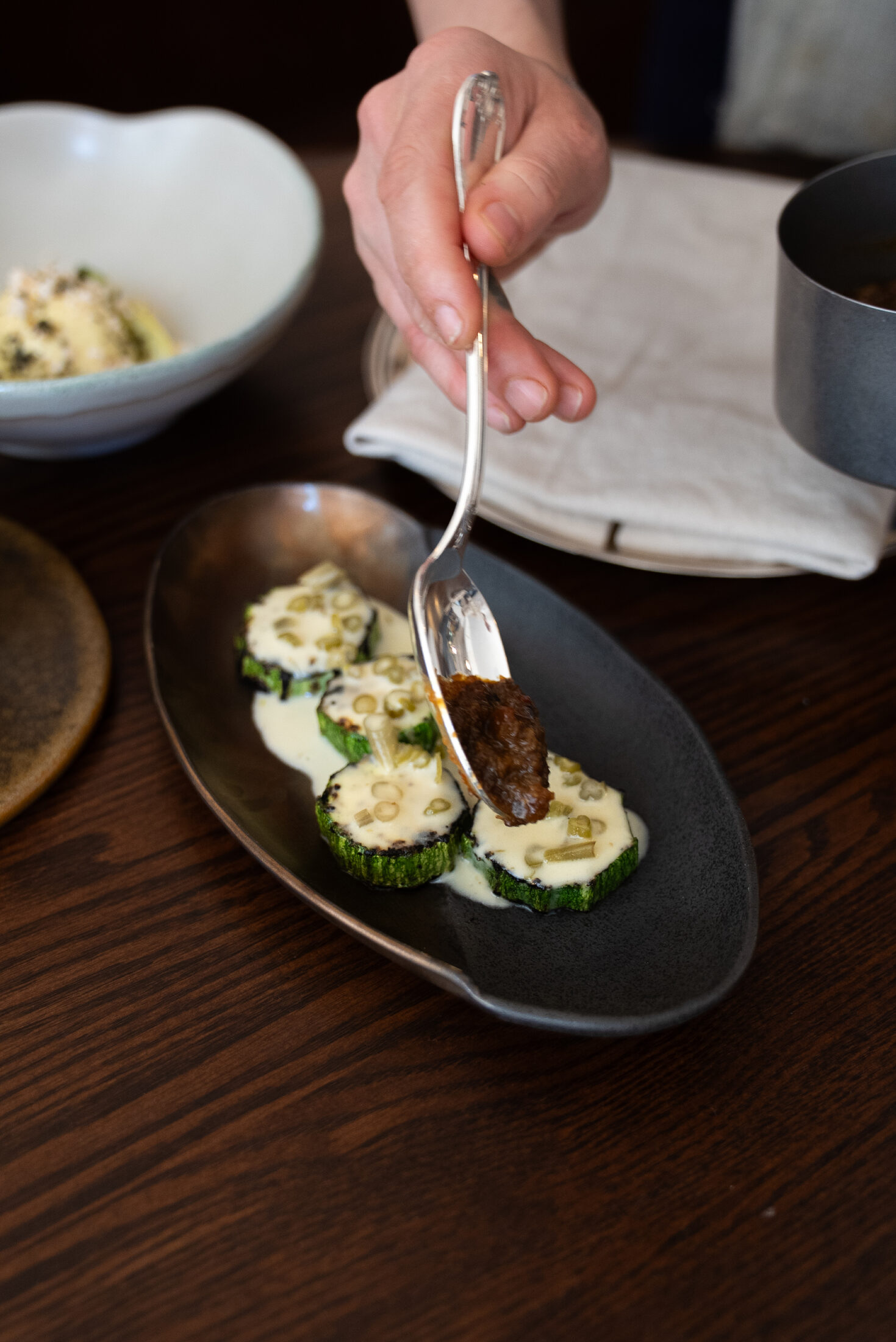 Grilled zucchini plated at the pass